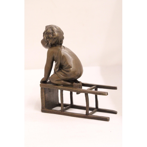 333 - A BRONZE FIGURE OF A CHILD ON A CHAIR - SIGNED