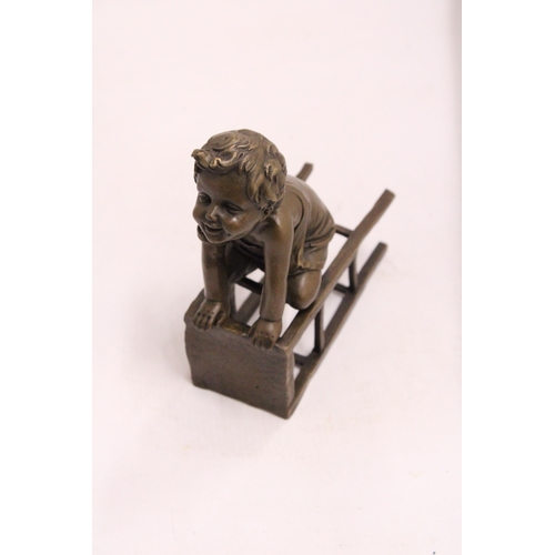 333 - A BRONZE FIGURE OF A CHILD ON A CHAIR - SIGNED