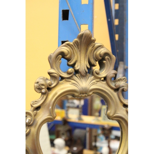 357 - AN ORNATE GILT FRAMED MIRROR