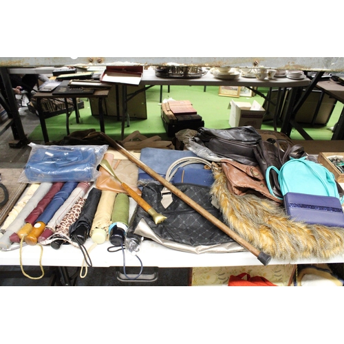 914 - A LARGE QUANTITY OF ITEMS TO INCLUDE UMBRELLAS, HANDBAGS, SATCHELS, A WALKING STICK ETC