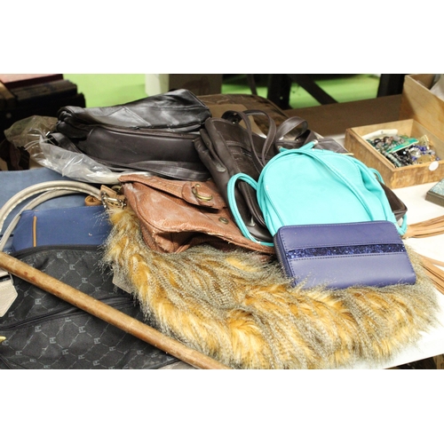 914 - A LARGE QUANTITY OF ITEMS TO INCLUDE UMBRELLAS, HANDBAGS, SATCHELS, A WALKING STICK ETC