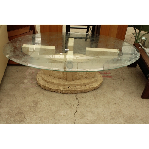 2620 - AN OVAL GLASS COFFEE TABLE ON A STONE EFFECT BASE 51