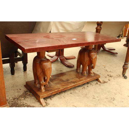 2733 - A HARDWOOD COFFEE TABLE ON PEDESTALS IN THE FORM OF ELEPHANTS, 36