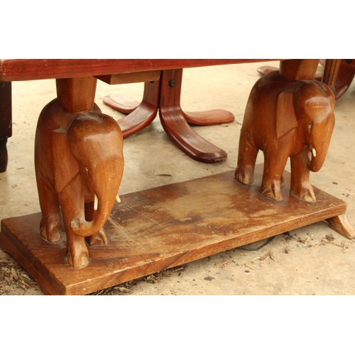 2733 - A HARDWOOD COFFEE TABLE ON PEDESTALS IN THE FORM OF ELEPHANTS, 36