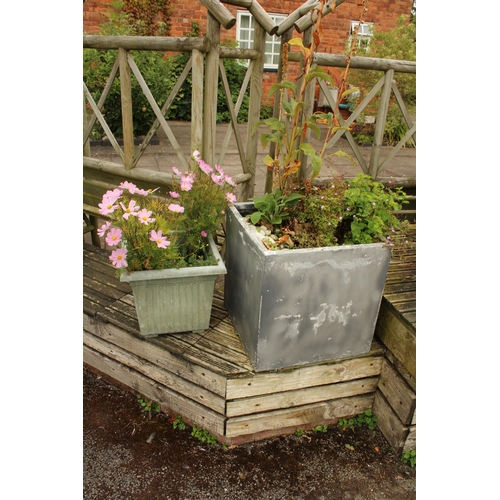 3289 - A LARGE CEMENT FIBRE PLANTER AND A FURTHER PLASTIC TUB BOTH CONTAINING PLANTS