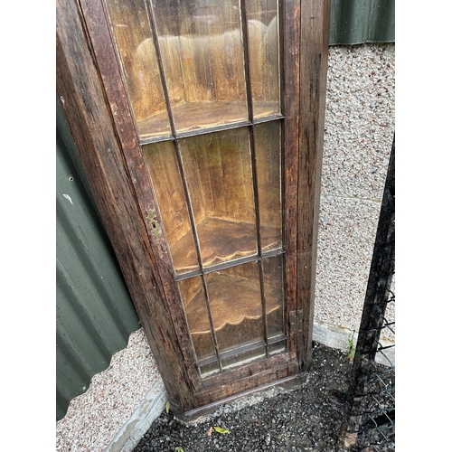 3553 - AN OAK GLAZED CORNER CUPBOARD WITH H BRASS HINGES