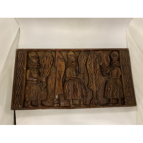 105 - AN EARLY CARVED AFRICAN WOODEN PLAQUE - 61 X 31 CM