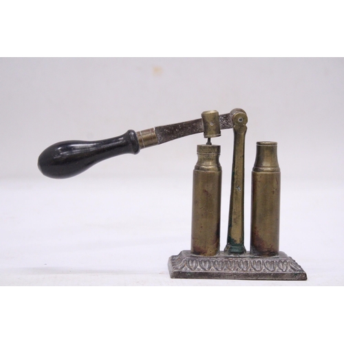 205 - AN UNUSUAL VINTAGE BRASS BULLET CAP SEALER