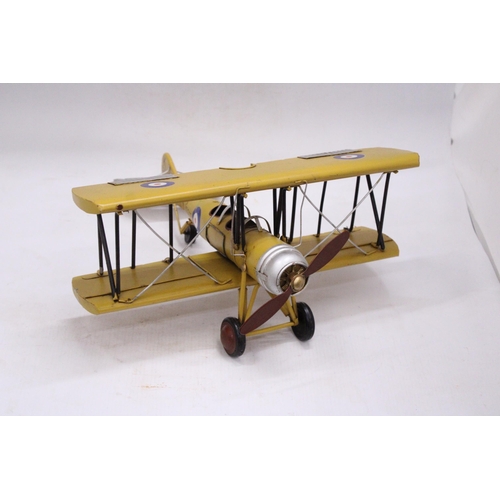 243 - A YELLOW TIN PLATE BI-PLANE