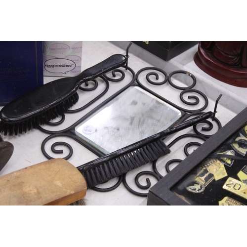 294 - A VINTAGE WROUGHT IRON FRAMED MIRROR WITH SHOE SHINE GROOMING BRUSHES TOGETHER WITH FURTHER BRUSHES,... 