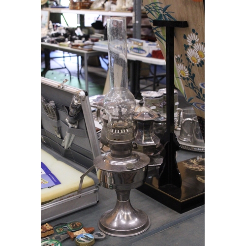 337 - A LARGE WHITE METAL OIOL LAMP, HEIGHT 59CM