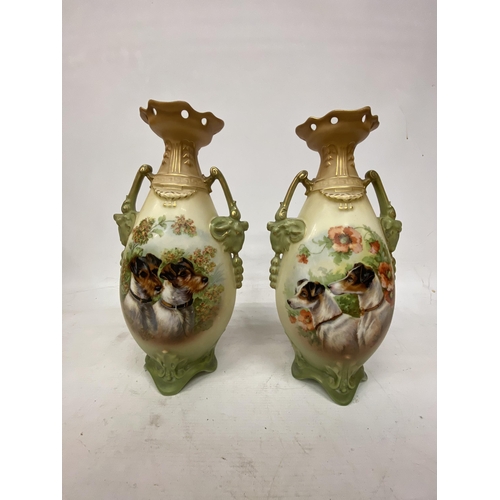 44 - A PAIR OF ANTIQUE VASES WITH TWIN HANDLES IN THE SHAPE OF GOATS DEPICTING SCHNAUZER DOGS - 30.5 CM