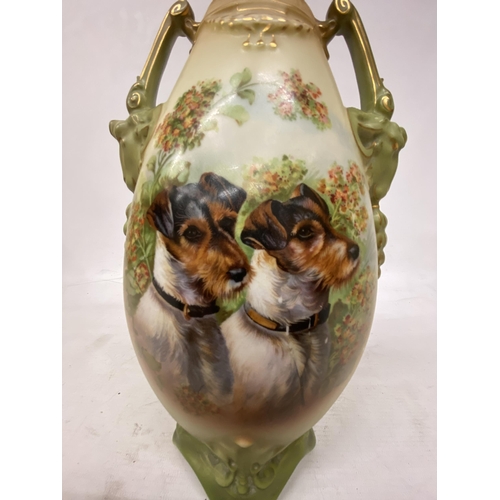 44 - A PAIR OF ANTIQUE VASES WITH TWIN HANDLES IN THE SHAPE OF GOATS DEPICTING SCHNAUZER DOGS - 30.5 CM