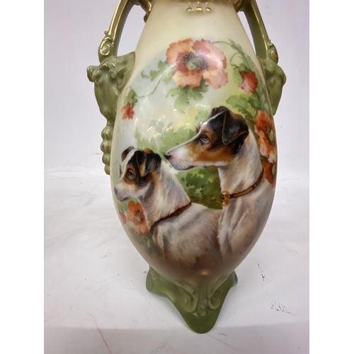 44 - A PAIR OF ANTIQUE VASES WITH TWIN HANDLES IN THE SHAPE OF GOATS DEPICTING SCHNAUZER DOGS - 30.5 CM