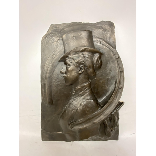 53 - A BRONZED  RESIN RELIEF PLAQUE OF A LADY JOCKEY WITH A TOP HAT CIRCLED WITH A HORSESHOE - 28 CM AT T... 