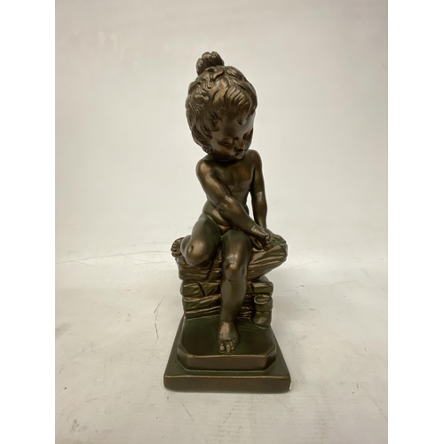 54 - A GIANNELLI STYLE BRONZE EFFECT FIGURE OF A CHILD SITTING ON A ROCK - 32.5 CM