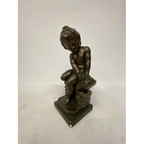 54 - A GIANNELLI STYLE BRONZE EFFECT FIGURE OF A CHILD SITTING ON A ROCK - 32.5 CM