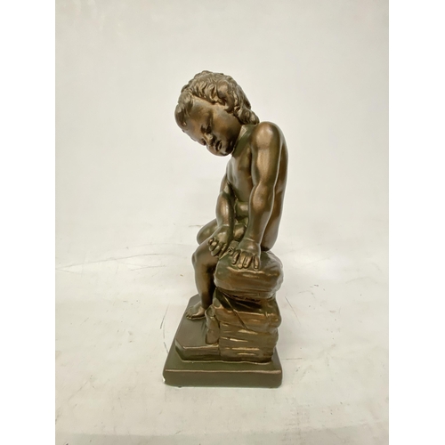 54 - A GIANNELLI STYLE BRONZE EFFECT FIGURE OF A CHILD SITTING ON A ROCK - 32.5 CM