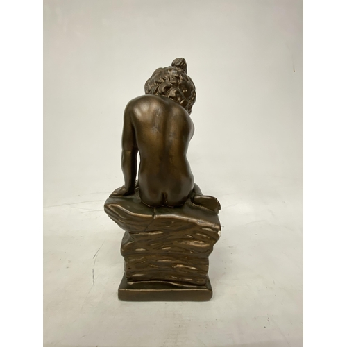 54 - A GIANNELLI STYLE BRONZE EFFECT FIGURE OF A CHILD SITTING ON A ROCK - 32.5 CM