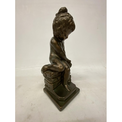 54 - A GIANNELLI STYLE BRONZE EFFECT FIGURE OF A CHILD SITTING ON A ROCK - 32.5 CM