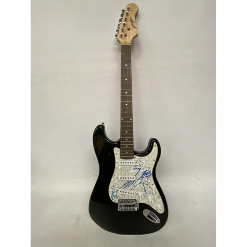 74 - A ONE DIRECTION SIGNED GUITAR SIGNED BY ALL FIVE MEMBERS OF THE BAND INCLUDING HARRY STYLES WITH CER... 