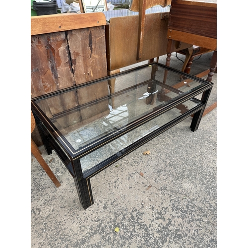 A BLACK AND GOLD TWO TIER COFFEE TABLE, 42