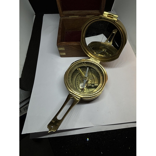 131 - A BRASS NAUTICAL COMPASS WITH SPIRIT LEVEL COMPLETE WITH WOODEN CASE