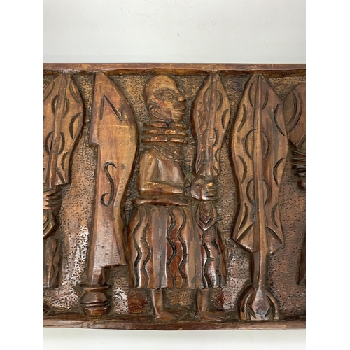 105 - AN EARLY CARVED AFRICAN WOODEN PLAQUE - 61 X 31 CM