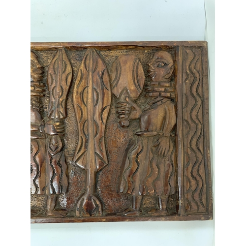 105 - AN EARLY CARVED AFRICAN WOODEN PLAQUE - 61 X 31 CM