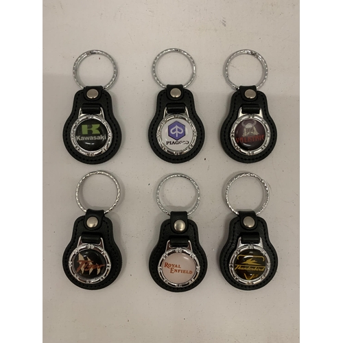 125 - A QUANTITY OF MOTORCYCLE KEY RINGS TO INCLUDE KAWASAKI LIME, PIAGGIO, ROYAL ENFIELD, T/BIRD ETC.,