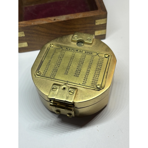 131 - A BRASS NAUTICAL COMPASS WITH SPIRIT LEVEL COMPLETE WITH WOODEN CASE