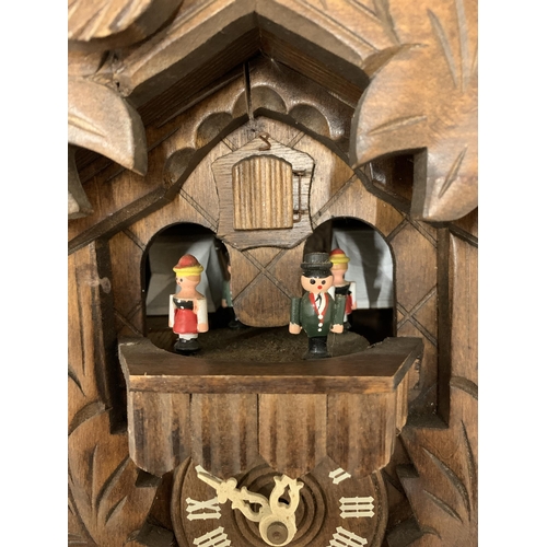 158 - A VINTAGE BLACK FOREST SWISS MADE BY REUGE ROMANCE CUCKOO CLOCK