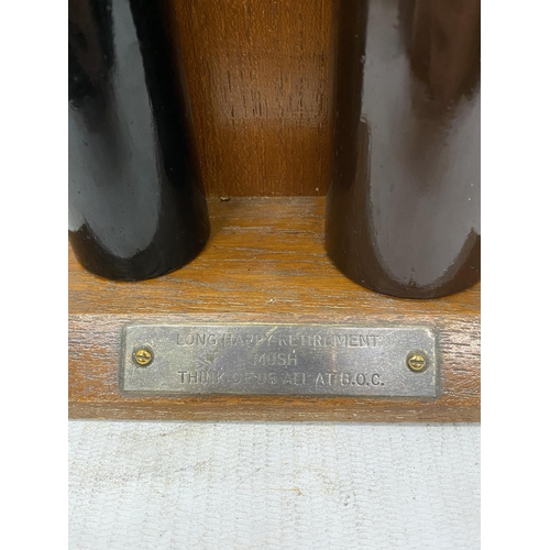 16 - TWO MINIATURE GAS CYLINDERS ON A WOODEN STAND PRESENTED BY ALL AT B.O.C. AS A RETIREMENT GIFT