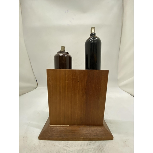 16 - TWO MINIATURE GAS CYLINDERS ON A WOODEN STAND PRESENTED BY ALL AT B.O.C. AS A RETIREMENT GIFT