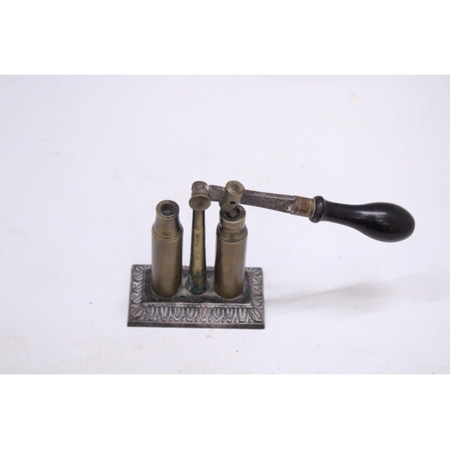 205 - AN UNUSUAL VINTAGE BRASS BULLET CAP SEALER