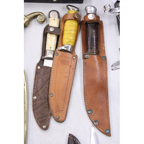 224 - THREE VINTAGE DAGGERS IN LEATHER SHEATHS