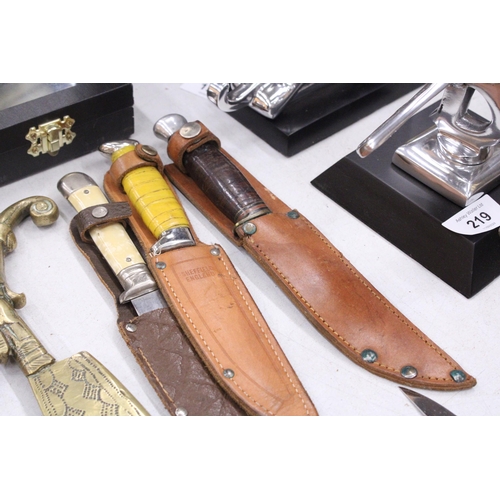 224 - THREE VINTAGE DAGGERS IN LEATHER SHEATHS