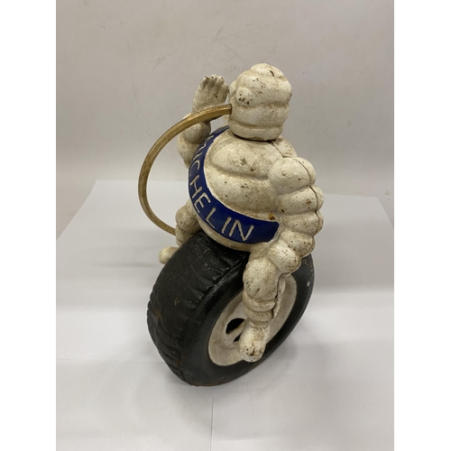 23 - A CAST MICHELIN MAN ON TYRE