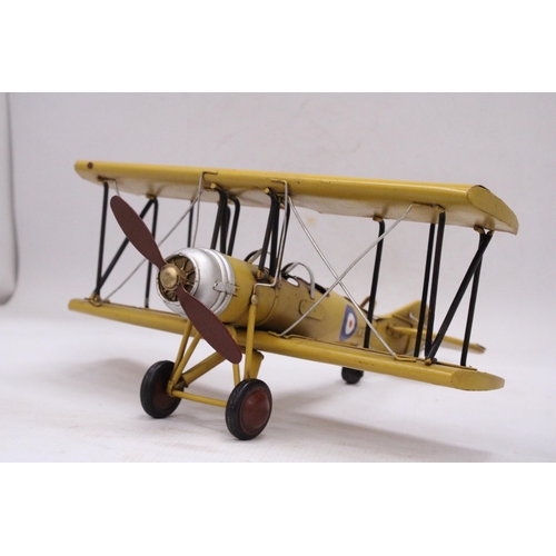 243 - A YELLOW TIN PLATE BI-PLANE