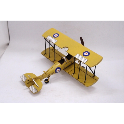 243 - A YELLOW TIN PLATE BI-PLANE