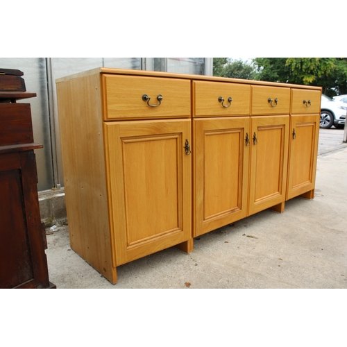 2825 - A MODERN OAK EFFECT SIDEBOARD ENCLOSING FOUR DRAWERS AND FOUR CUPBOARDS, 72