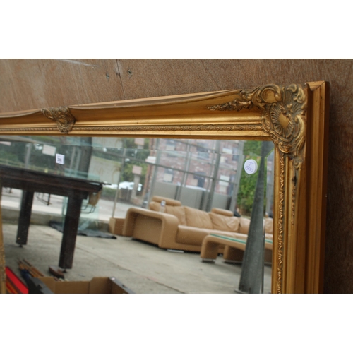 2808 - A LARGE GILT FRAMED BEVEL EDGE WALL MIRROR, 50