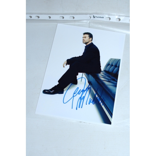 100 - A SIGNED PHOTOGRAPH OF GEORGE MICHAEL - WHIST WE BELIEVE THE SIGNATURE TO BE GENUINE, THERE IS NO CO... 