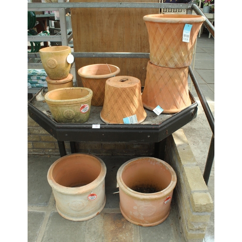 19 - DISPLAY STAND AND ELEVEN TERRACOTTA POTS PLUS VAT