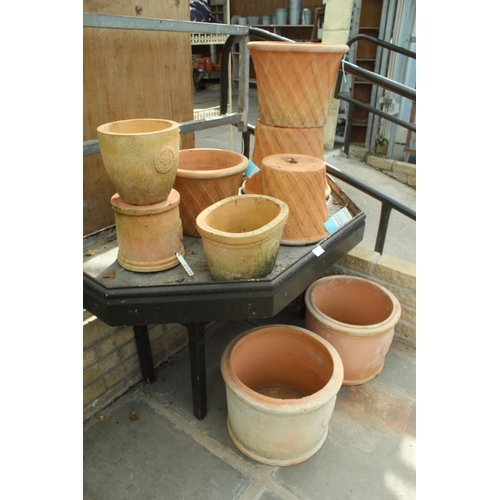 19 - DISPLAY STAND AND ELEVEN TERRACOTTA POTS PLUS VAT