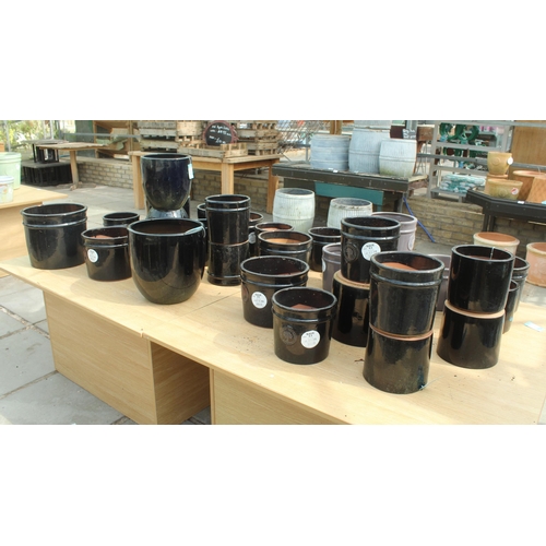 20 - TWO DISPLAY STANDS AND THIRTY BLACK AND GREY TERRACOTTA POTS  PLUS VAT