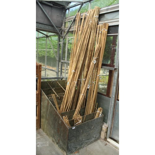 30 - WOODEN STAND AND QUANTITY OF GARDEN CANES  PLUS VAT