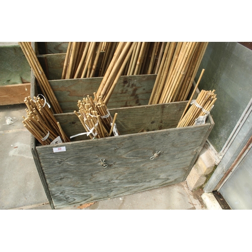 30 - WOODEN STAND AND QUANTITY OF GARDEN CANES  PLUS VAT