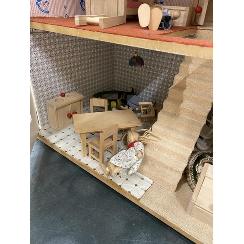 101A - A WOODEN DOLLS HOUSE WITH A QAUNTITY OF FURNITURE AND FIGURES