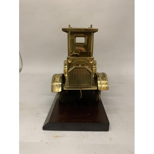 106 - A SOLID BRASS TAXI MODEL ON A WOODEN PLINTH